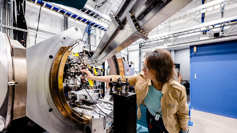 Woman working on a machine smiling.