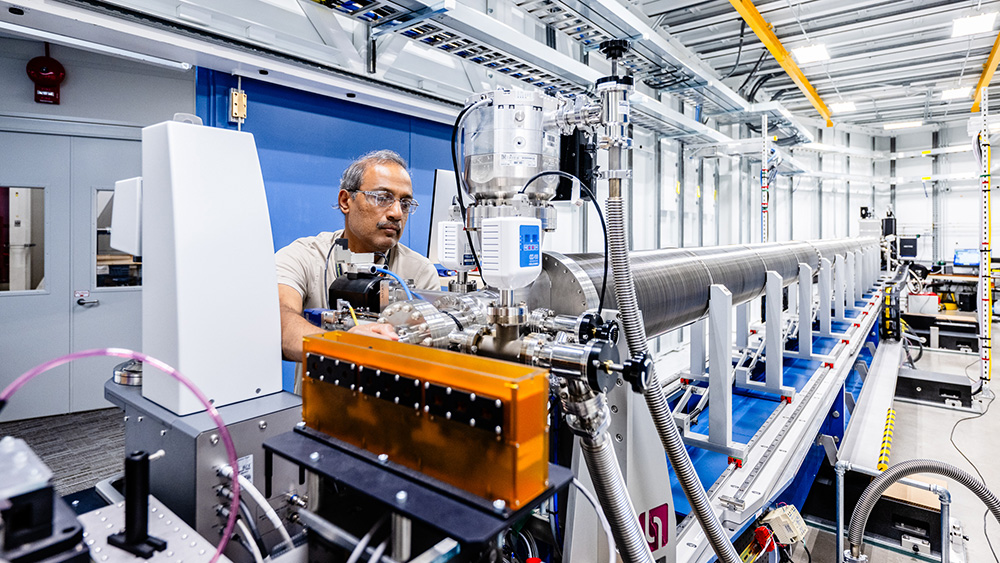 Man working on a machine with safety glasses.