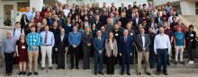 A group of attendees of the HPCAT workshop arrayed on the staircase leading to the Advanced Photon Source facility.