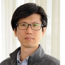 Headshot of a man wearing glasses.